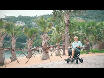 Video of an elderly man driving a motorized wheelchair outdoors.